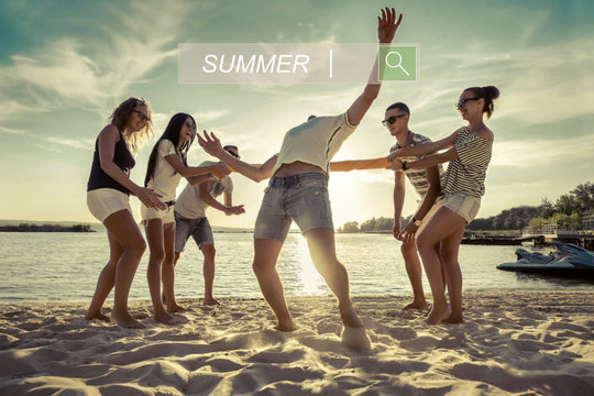 Friends funny game on the beach under sunset sunlight.