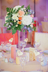 Wedding guest table decorated with bouquet and settings