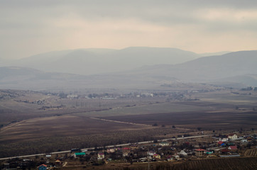 plains and mountains in fog