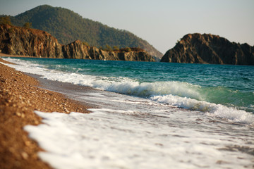 Obraz premium Coast of Mediterranean Sea on background of green mountains