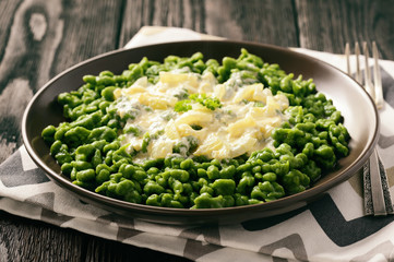 German dumplings (spaetzle) with spinach and cheese sauce.