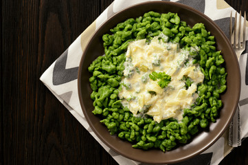 German dumplings (spaetzle) with spinach and cheese sauce.