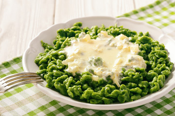 German dumplings (spaetzle) with spinach and cheese sauce.