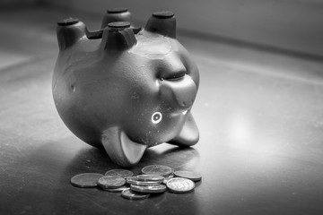 Piggy bank upside down on table, financial problems and debt concept.