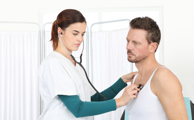 Doctor examining patient with stethoscope in medical office