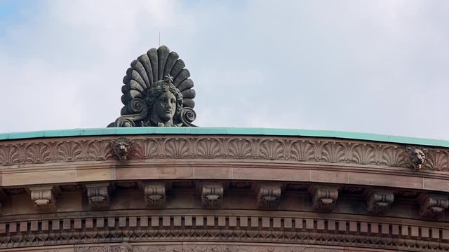 the sphinx head on the roof of the old national gallery views over Berlin, Stature of the roof of the old National Gallery in Berlin