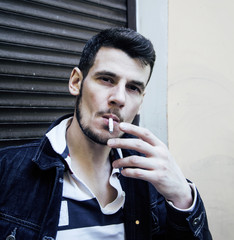 middle age man smoking cigarette on bacyjard, stylish tough guy,