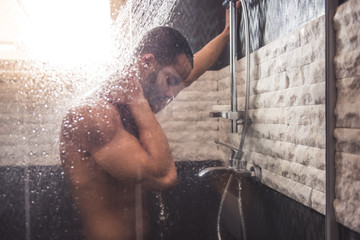 Afro American man taking shower