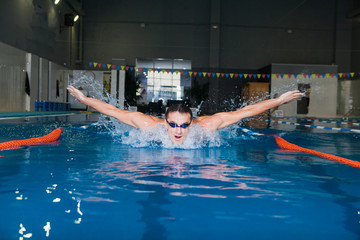 Man swimming with butterfly style in a swimming pool