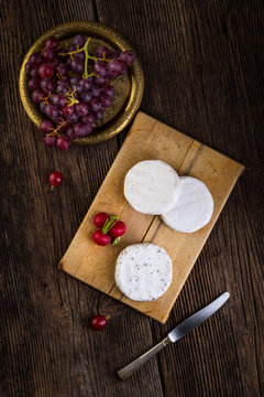 Cheese with white mold, grapes and radish