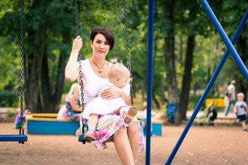 Small cute baby and nice mom outdoors
