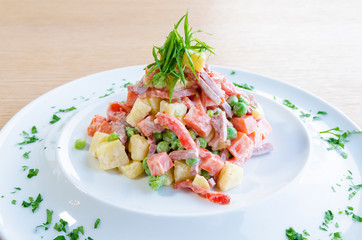 Traditional Russian delicious salad on a white plate