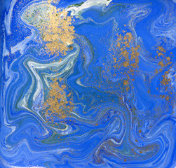 Blue and gold liquid texture. Hand drawn marbling background. Ink marble abstract pattern