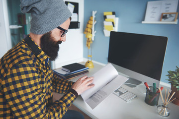 Bearded man double checking documents