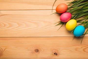 painted Easter eggs on wooden boards in the corner of the top view