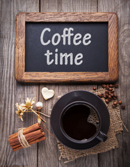cup of hot espresso among autumn plants on wooden vintage table, coffee on the old board grunge including dried plants