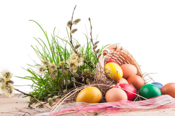 Easter eggs in the basket on a wooden table