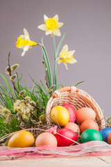 Easter eggs in the basket on a wooden table