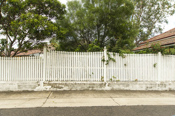 White Picket fence in front of a house Copyspace.