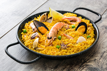 Traditional spanish seafood paella on wooden background
