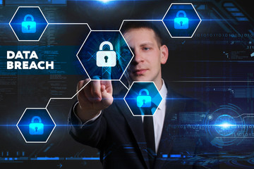 Business, Technology, Internet and network concept. Young businessman working on a virtual blackboard of the future, he sees the inscription: data breach
