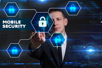 Business, Technology, Internet and network concept. Young businessman working on a virtual blackboard of the future, he sees the inscription: mobile security