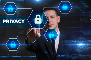 Business, Technology, Internet and network concept. Young businessman working on a virtual blackboard of the future, he sees the inscription: privacy