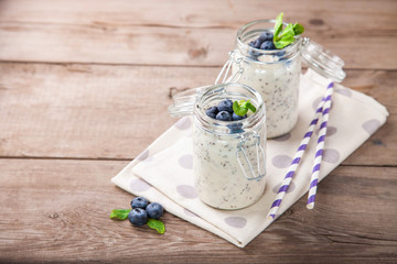 Smoothie in seeds of a chia and blueberry in a jar on a table. Selective focus. Copy space