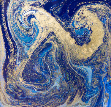 Blue and gold liquid texture. Hand drawn marbling background. Ink marble abstract pattern