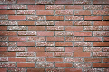background texture of a wall made of decorative brick-red stone