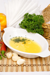 Aioli sauce of Provence in white saucers decorated with parsley and fennel on a background of vegetables and cutlery