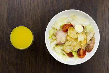 Caesar salad orange juice delicious healthy food tomatoes croutons Parmesan cheese and fresh mozzarella