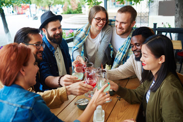 Restful buddies with drinks spending time in cafe