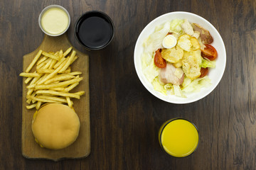 Caesar sauce salad cheeseburger fries orange juice coca delicious healthy food tomatoes croutons Parmesan cheese fresh mozzarella  junk  fast food cheese meat bad food not healthy