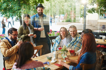 Young people communicating by drink in cafe
