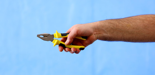 hands holding construction tools,  pliers
