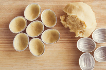 In the kitchen from shortcrust pastry baked tasty nuts shapes with sweet, brown cream - condensed milk. Homemade pastries.