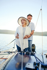 Laughing couple having romantic voyage on yacht