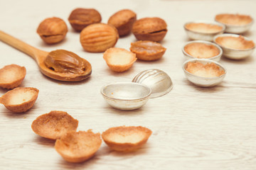In the kitchen from shortcrust pastry baked tasty nuts shapes with sweet, brown cream - condensed milk. Homemade pastries.