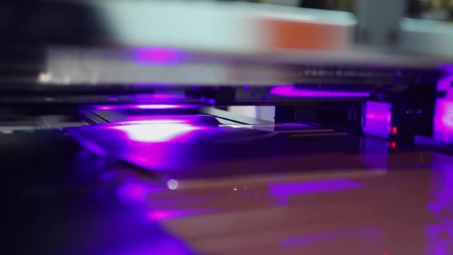 UV printing machine in action, close up at machine head