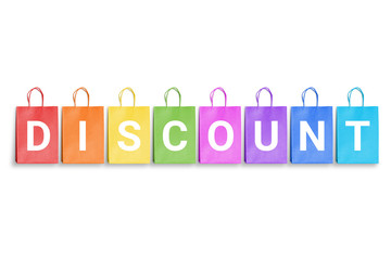 Discount word written on colorful shopping bags. Free space for text.