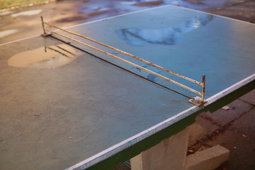 Abstract detail of old ping pong (table tennis) table placed in the middle of aged housing project as a symbol of sport activities placed in older districts 
