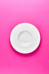 Empty plate on the pink background