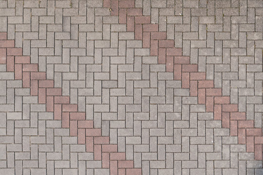 Pavimentazione stradale decorativa in mattoncini di pietra grigio e rosa