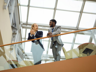 Lawyers in formalwear having talk in business center