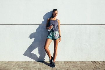 Healthy young woman resting after workout