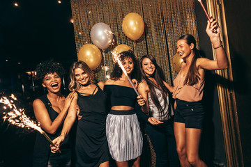 Stylish girls enjoying party at nightclub - obrazy, fototapety, plakaty