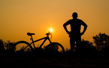 Fototapeta na wymiar Silhouettes of mountain bike with man in action something