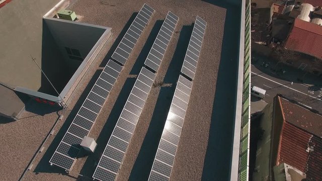 Aerial shot around mounted solar panels on the roofs. Ecologic energy concept
