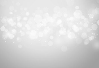 Grey sparkles glitter and rays lights bokeh abstract holiday background/texture.